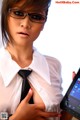 A woman in glasses holding a tablet computer.