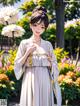 A woman in a white kimono standing in front of flowers.