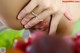 A close up of a woman's butt with a bunch of fruit in the background.