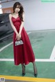 a woman in a red dress standing on a basketball court