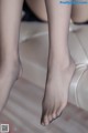 A close up of a woman's legs on a couch.