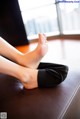 A woman sitting on a couch with her feet up.