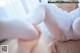 A woman in white stockings and a tutu is laying on the floor.