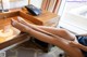 A woman sitting at a desk with her legs crossed.