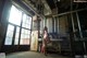 A naked woman standing in an industrial building.